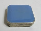 an image of a small blue box sitting on top of a white table