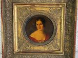 an old picture of a woman in a red dress in a gold frame