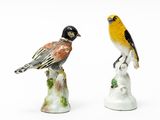 two figurines of birds sitting on top of each other
