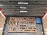 a lot of tools in a tool box on the floor