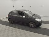 a picture of a small black car parked in a garage