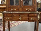 a wooden cabinet with a glass door on it