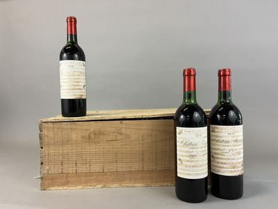 three bottles of wine sit in front of a wooden box