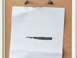 a piece of paper taped to a bulletin board