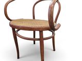 an image of a wooden chair with a woven seat on a white background