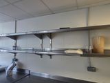a kitchen with stainless steel shelvings and a window