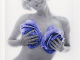 black and white photograph of a woman in a bikini holding two towels
