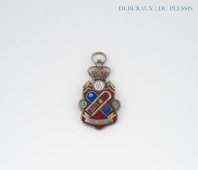 a red and blue pendant with a crown on it