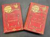 two red books sitting on top of a table next to each other