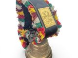 a bell with a book on top of it on a white background