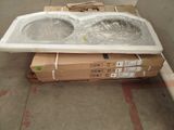 two sinks sitting on top of a box in a warehouse