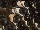 many bottles of wine that are stacked on a rack