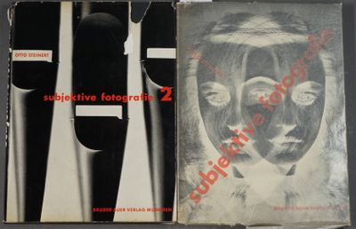 three books with black and white covers on them sitting on top of a table