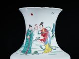 a white vase with a painting on it on a black background