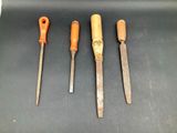 four different types of tools are lined up on a black surface