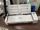 a white printer sitting on a desk next to a box