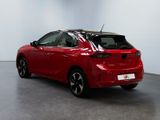 the rear end of a red car parked in a showroom