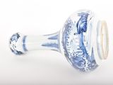 a blue and white vase sitting on a white surface