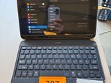 a laptop computer sitting on a table with a price tag on it