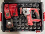 une boîte à outils contenant une perceuse, un marteau et d'autres outils