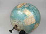 a large globe with a key on top of it