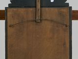 a clock that is sitting on top of a wooden table