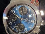 a close up of a watch with a blue face