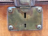 a close up view of a metal lock on a piece of luggage