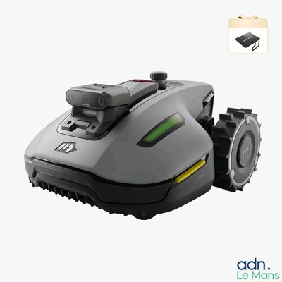 a robotic lawn mower that is sitting on a white surface
