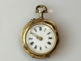 a gold pocket watch with roman numerals on it