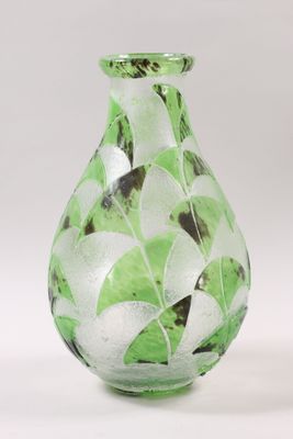 a glass vase with a green and white design on it