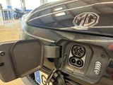 a close up of a car with an electric charger attached to it