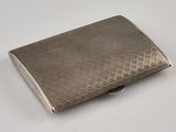 an antique silver cigarette case on a white background