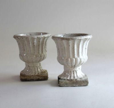 two vases that are sitting on a table