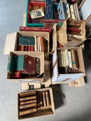 boxes of books are stacked on top of each other on the floor