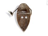 an image of a wooden mask hanging on a white wall