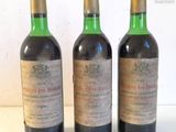 three bottles of wine sitting on top of a table next to each other