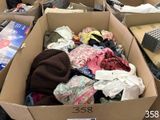 a box full of clothes sitting on the floor in a store