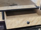 a small drawer that is open on a table