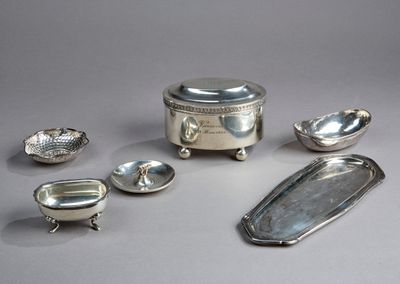 several pieces of silverware are arranged on a gray surface