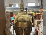 a statue of a buddha sitting on a table in a room