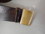 a brown belt with a gold buckle on it