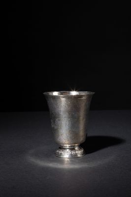 a silver cup that is sitting on a table