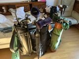 many golf clubs in a bag on the floor