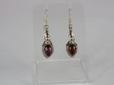 silver earrings with garnets and garnets on them