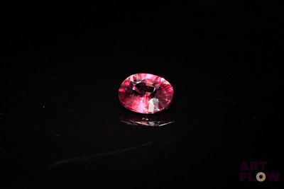 a pink diamond on a black surface