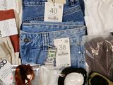 a box of assorted clothing and sunglasses in it