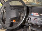 a steering wheel and dashboard of a car in a garage