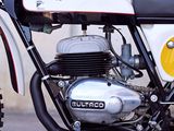 a white and black motorcycle parked in front of a building