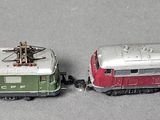 two toy trains sitting next to each other on a table